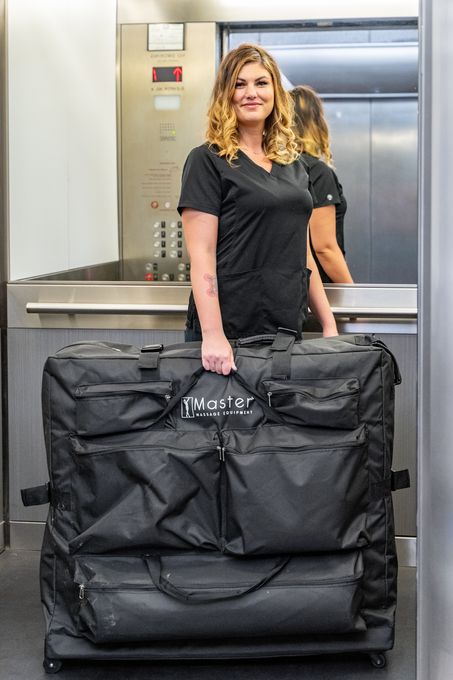 Shauna mobile with her massage table case, bringing the spa to you